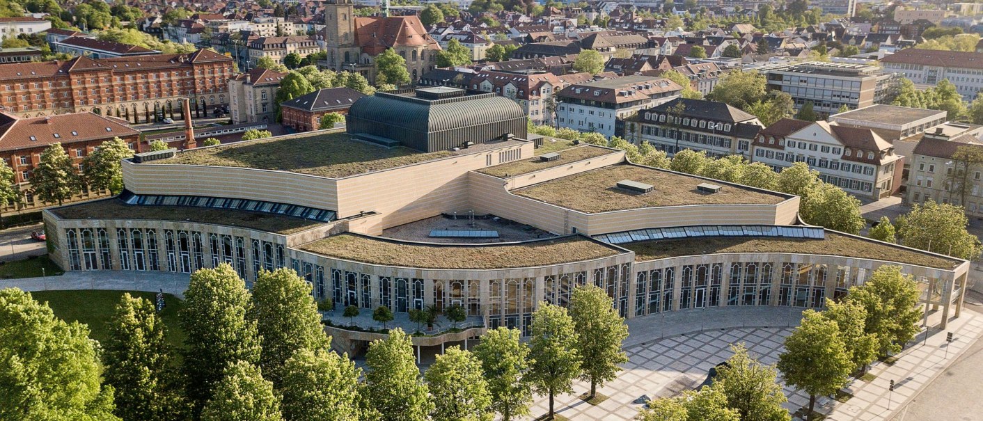 Aerial view of the Forum am Schlosspark in Ludwigsburg, surrounded by trees and urban architecture in sunny weather., © Stauch