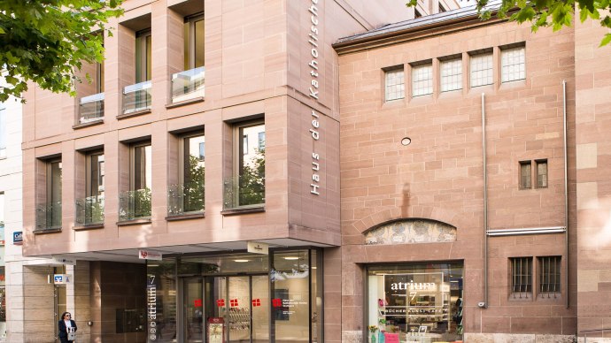 Modern fa&ccedil;ade of the House of the Catholic Church with large windows and an entrance to the Atrium 7 Caf&eacute;., &copy; hdkk_gf