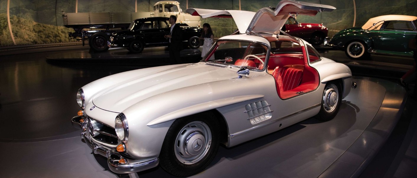 A white Mercedes-Benz 300 SL with open gullwing doors on display at the Mercedes-Benz Museum in Stuttgart., © Stuttgart-Marketing GmbH Sebastian Berger