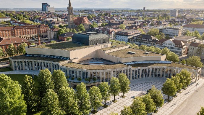 Aerial view of the Forum am Schlosspark in Ludwigsburg, surrounded by trees and urban architecture in sunny weather., © Stauch