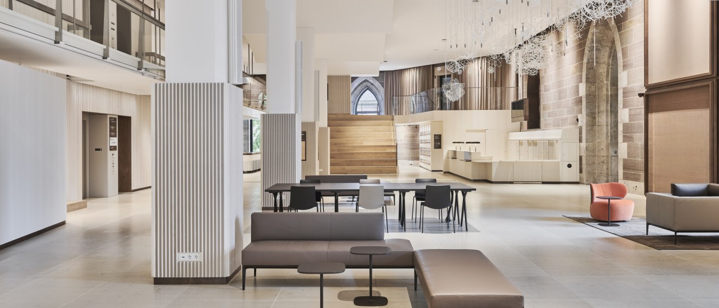 Modernes Interieur eines Schlosses mit eleganten Sitzmöbeln, hohen Decken und dekorativer Beleuchtung. Helle, offene Raumgestaltung., © Landesmuseum Württemberg, Simon Sommer Fotografie