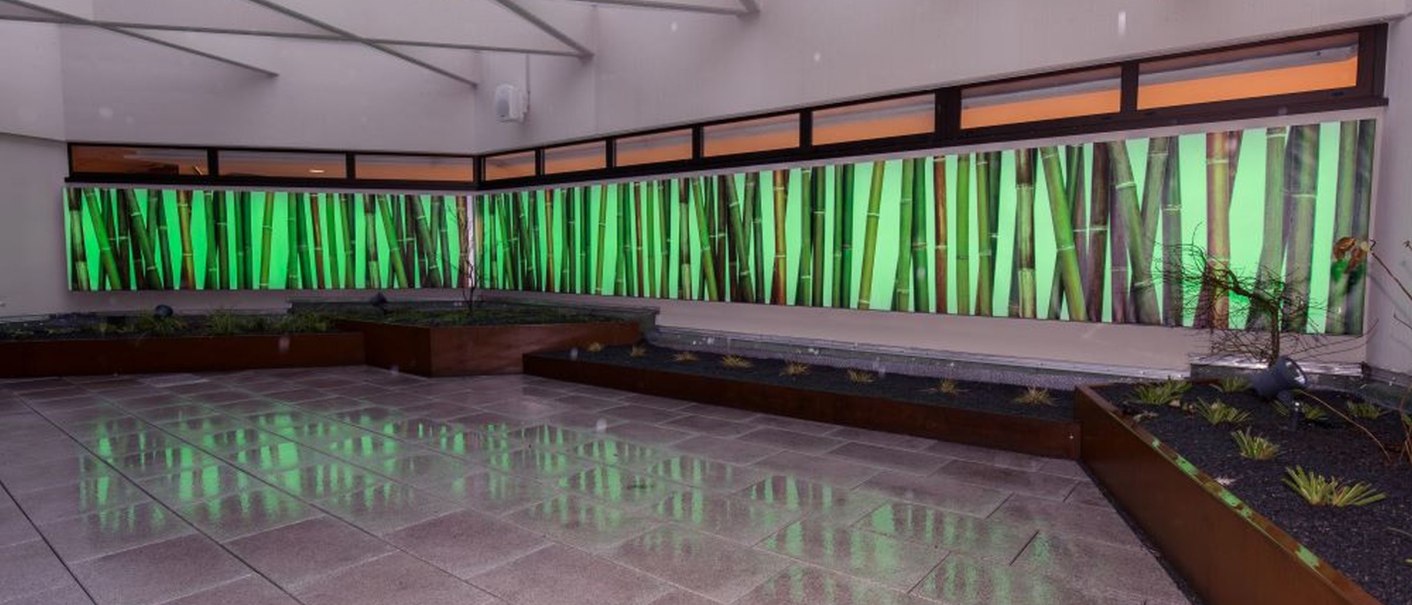 Modern foyer with green illuminated bamboo wall and shiny floor in the Kongresshalle Böblingen., © ccbs-gf