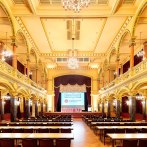 Magnificently decorated hall in the Ludwigsburg Music Hall with chandeliers, high ceilings and rows of tables and chairs., © Stauch