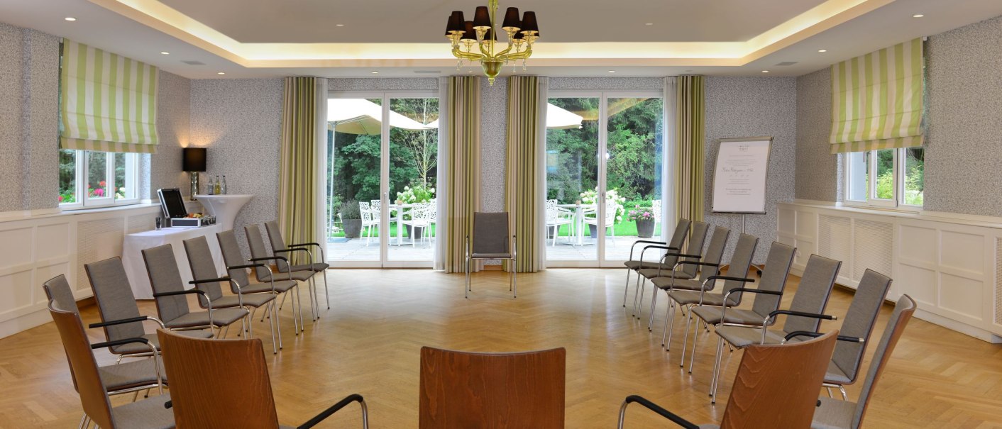 Bright conference room with a circle of chairs, wooden floor and large windows to the terrace with garden furniture., © WHS Bright conference room with a circle of chairs, wooden floor and large windows to the terrace with garden furniture., © WHS